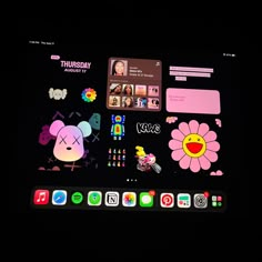 an apple tv with stickers on the screen in front of it's display