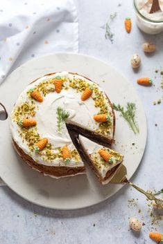 a cake with carrots and frosting on a plate