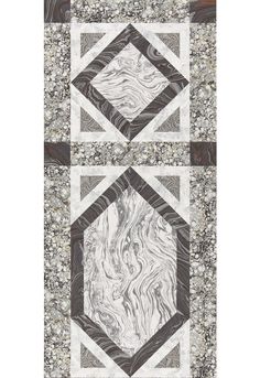 an abstract quilt with black and white designs on the front, grey and white design on the back