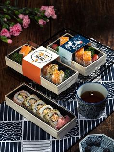 sushi and tea on a table with flowers