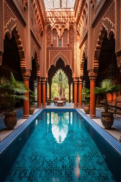 an indoor swimming pool in the middle of a building with columns and arches around it