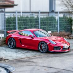 a red sports car parked in front of a building