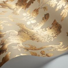 an image of a wallpaper with gold and white designs on the back of it