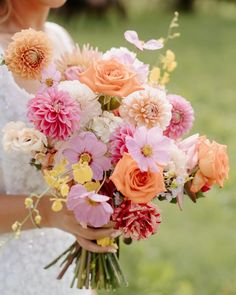 a woman holding a bouquet of flowers in her hands