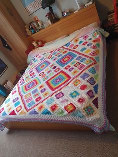 a crocheted blanket on top of a bed