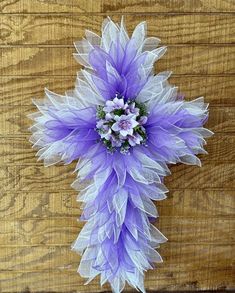 a purple and white flower on top of a wooden table