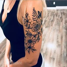 a woman with a flower tattoo on her arm