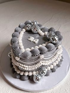 there is a cake on the table with shells and beads around it that look like seashells