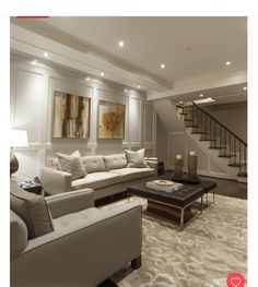 a living room filled with furniture and a stair case