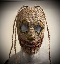 a creepy looking mask with long hair and eyes