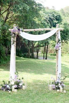 an outdoor ceremony setup with flowers and candles