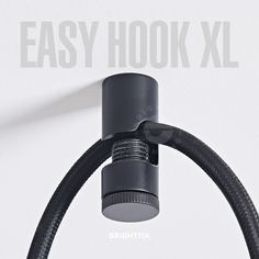 an easy hook is attached to the side of a wall mounted light fixture with black hoses