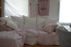 a white couch covered in lots of pillows