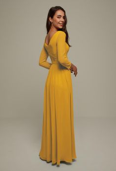 a woman in a yellow dress posing for the camera with her hands on her hips