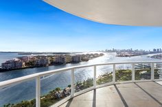 a balcony overlooking the water and city skyline