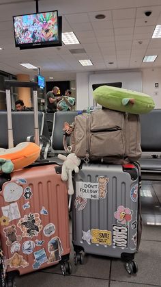 several suitcases stacked on top of each other in an airport