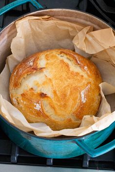 a loaf of bread sitting in a blue pot