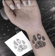 a woman's arm with a tattoo on it and an animal paw in the middle