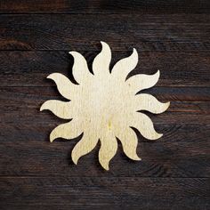 a wooden cutout of a sunflower on a wood background