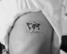 a woman with a small tattoo on her shoulder that reads, mom and the world