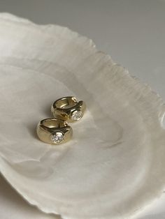 Our Ynez Dome Huggies truly are the epitome of everything a modern heirloom should be: classy, timeless, luxurious. This is a style that can go from day to night with oval-cut diamonds on each ear that adds a bit of extra. Best yet, this is a piece that you never have to take off. 14k solid gold - always Earrings weigh about 5.1 grams as a pair Earring diameter is 13.3mm Oval cut diamond SI 1-2 clarity Carat weight 0.44 diamond weight Sold as a pair Fall Rings, Round Diamond Ring, Bar Stud Earrings, Baroque Pearl Earrings, Star Pendant Necklace, Dope Jewelry, Earrings Diamond, Diamond Charm, Solid Gold Jewelry