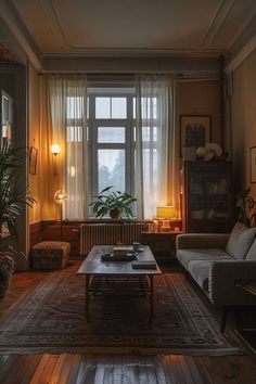 a living room filled with furniture and a large window next to a wooden coffee table