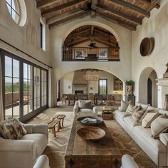 a living room filled with lots of furniture and a fire place in the middle of it