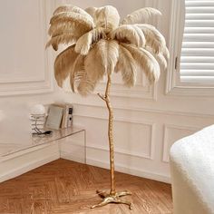 a large palm tree in a white room