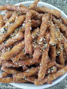 a white bowl filled with cheetos covered in sesame seeds