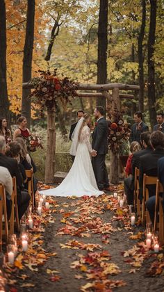 the bride and groom are getting married under an arbor with candles in front of them