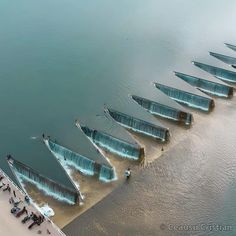 an aerial view of several boats in the water