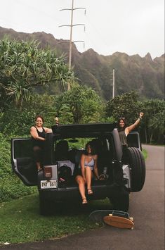 two women sitting in the back of a pick up truck