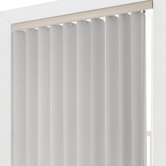 an open window with white vertical blinds