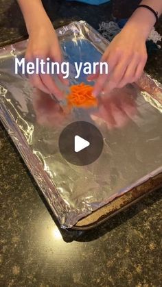 someone is making something with aluminum foil and carrots