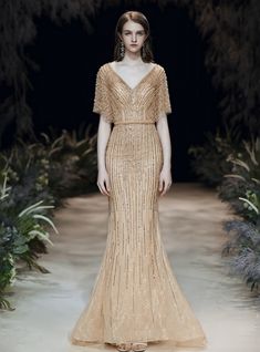 This enchanting dress showcases a strapless sweetheart neckline with a completely embellished bodice. A sensational beaded belt secures at the waist as a complete fabric skirt flares out in significant rates. Dress Akad, Dress Payet, Ancient Egyptian Dress, Dinner Wears, Short Sleeve Prom Dress, Gold Hijab, Short Sleeve Prom Dresses, Egyptian Dress, Sleeve Prom Dress