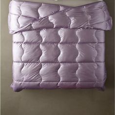 a purple comforter hanging on the wall