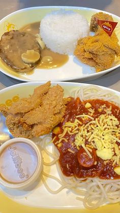 two plates filled with different types of food on top of a white and yellow plate