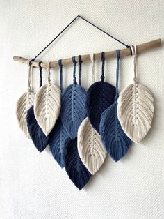 four blue and white leaves hanging on a wall