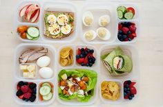 a plastic container filled with lots of different types of food on top of a wooden table