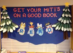 a bulletin board with christmas decorations hanging from it's sides and the words get your mits on a good book