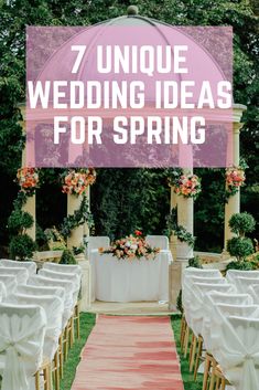 an outdoor ceremony with white chairs and pink flowers on the aisle