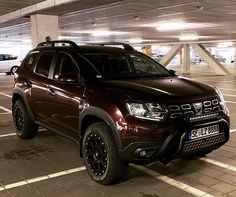 a dark colored suv parked in a parking garage