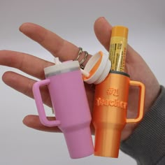 a person holding two different items in their hand, including a coffee cup and lighter