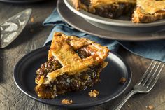 a slice of pecan pie on a black plate