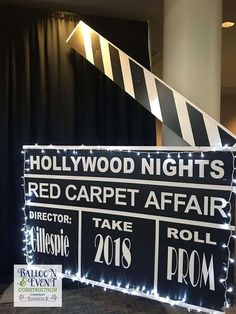 hollywood night's red carpet affair take roll prom sign with white lights and black background