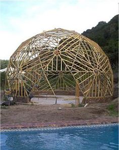 a large wooden structure sitting next to a body of water