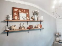 two wooden shelves with some pumpkins on them