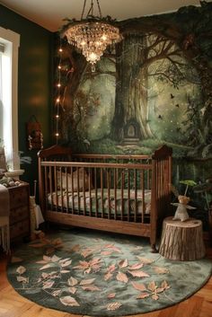 a baby's room with a tree mural on the wall and a chandelier hanging from the ceiling