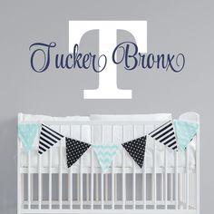 a white crib with a blue and black banner on it