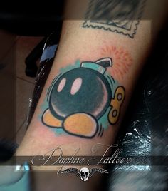 an image of a cartoon character tattoo on the arm